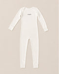 A long-sleeve eczema sleepsuit in off-white, featuring the brand name 'suppla' printed in black script on the chest, laid flat against a light beige background.