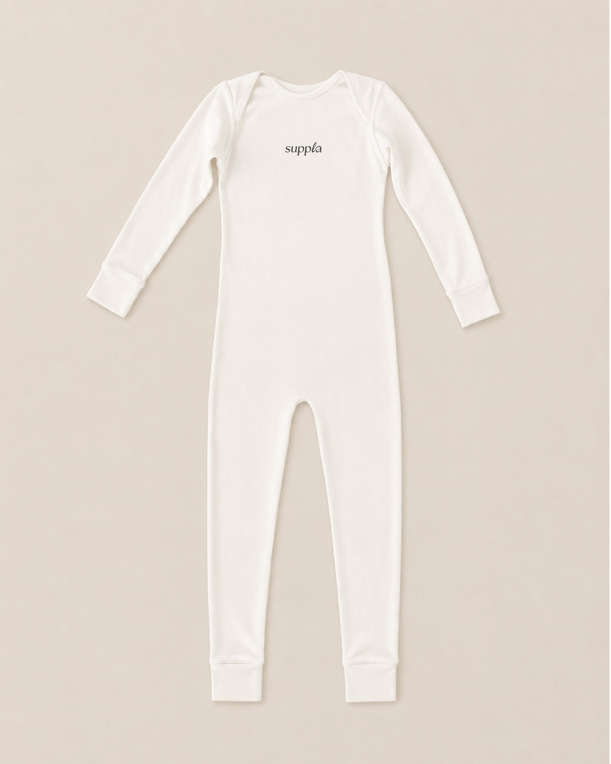 A long-sleeve eczema sleepsuit in off-white, featuring the brand name 'suppla' printed in black script on the chest, laid flat against a light beige background.